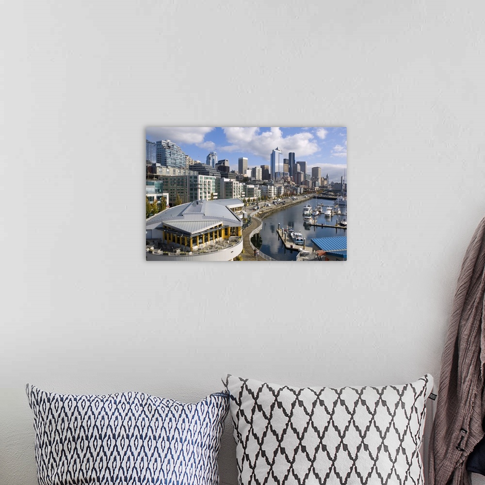 A bohemian room featuring Puffy clouds over Seattle, Washington skyline seen from Elliot Bay with boats in the foreground.