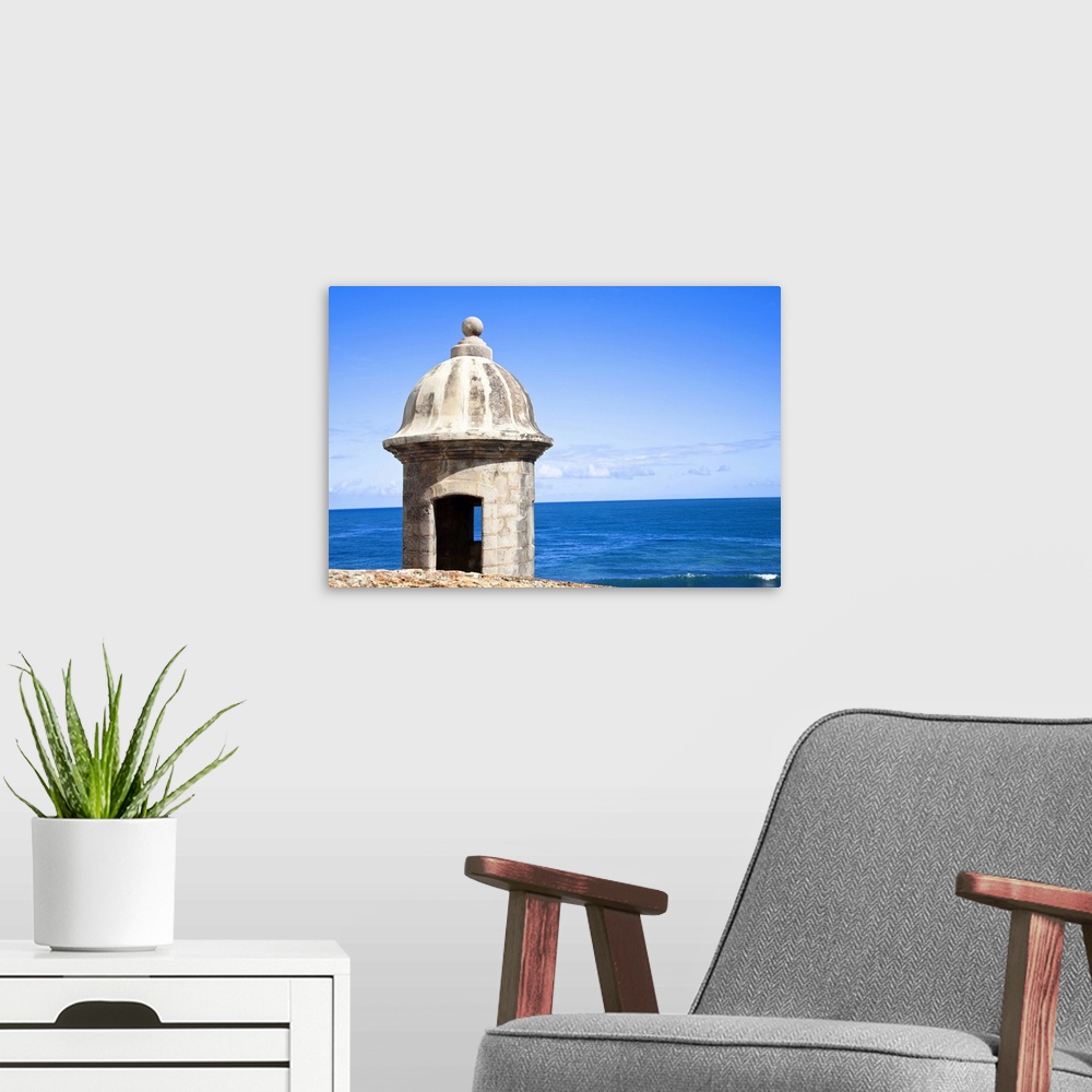 A modern room featuring San Juan, Puerto Rico - An old stone watchtower looks out over the ocean. Horizontal shot.