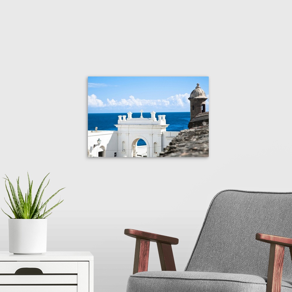 A modern room featuring San Juan, Puerto Rico - A white building holds the entrance to a cemetery while above is an ancie...