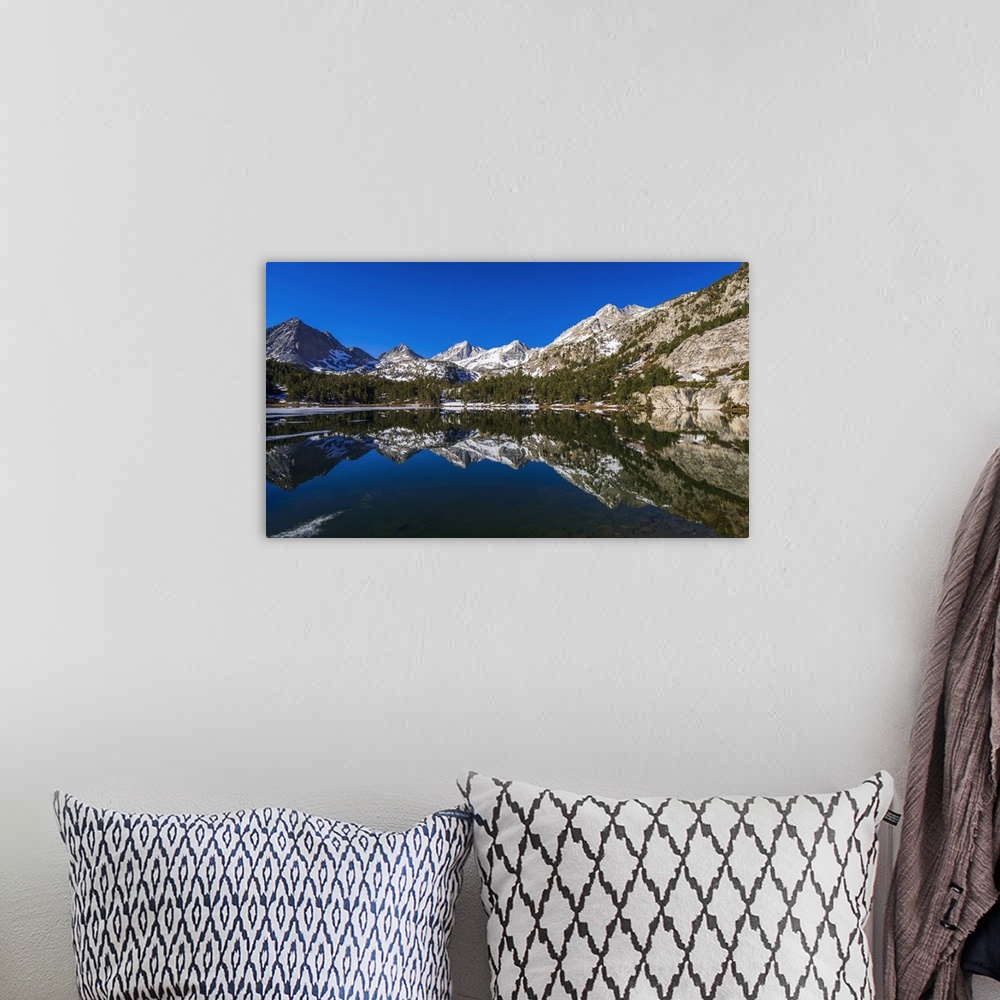 A bohemian room featuring Sierra peaks reflected in Long Lake, Little Lakes Valley, John Muir Wilderness, California, USA.