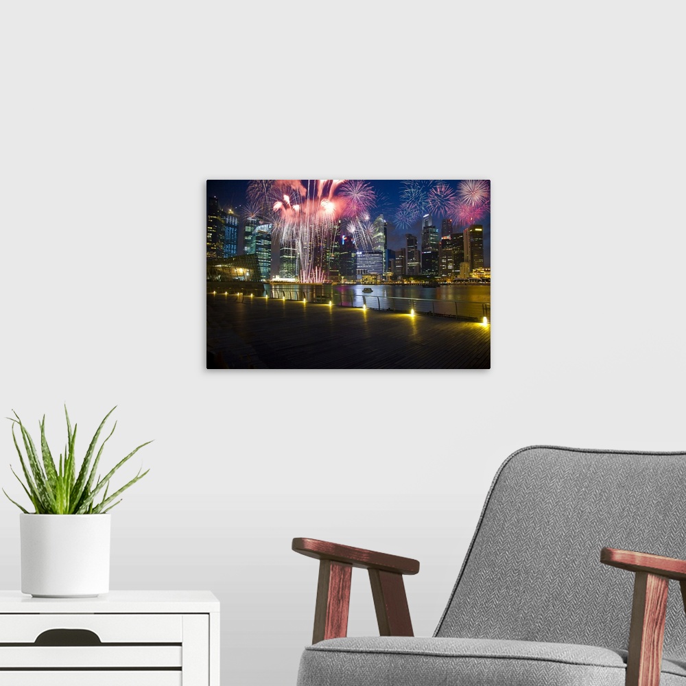 A modern room featuring Singapore. Fireworks in downtown area.