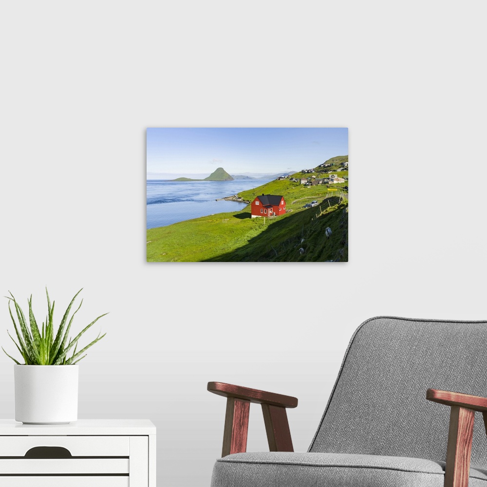 A modern room featuring Koltur island at sunrise, the island Vagar in the background, village Velbastadur in the foregrou...