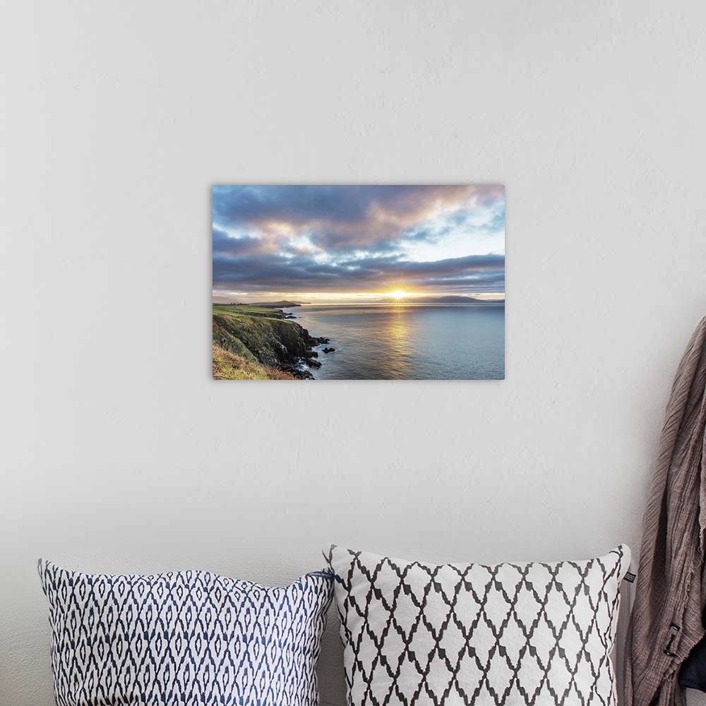 A bohemian room featuring Sunrise over Dingle Bay as fishing boats heads out in County Kerry, Dingle, Ireland