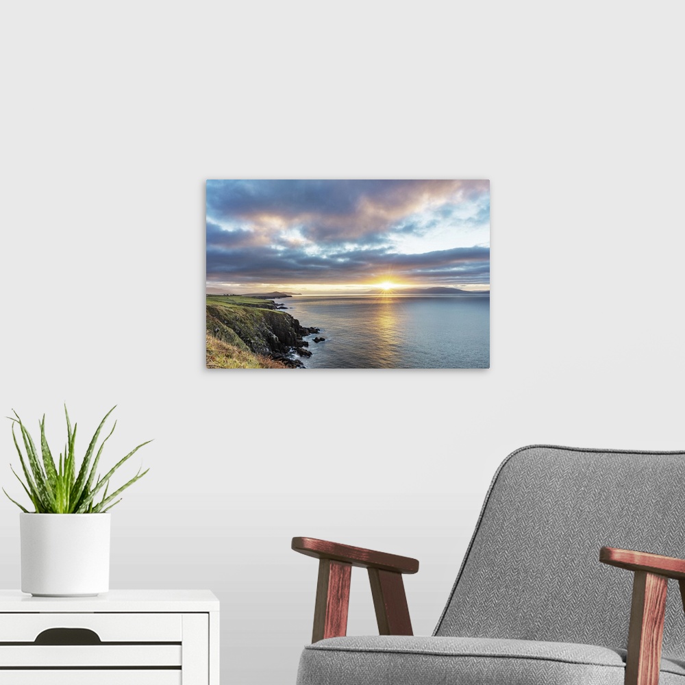 A modern room featuring Sunrise over Dingle Bay as fishing boats heads out in County Kerry, Dingle, Ireland