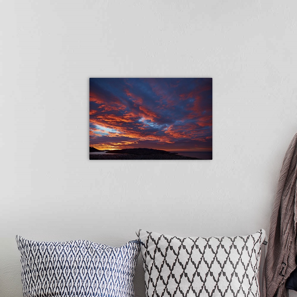 A bohemian room featuring Sunrise over Otago harbor and Pacific Ocean, Dunedin, South Island, New Zealand.