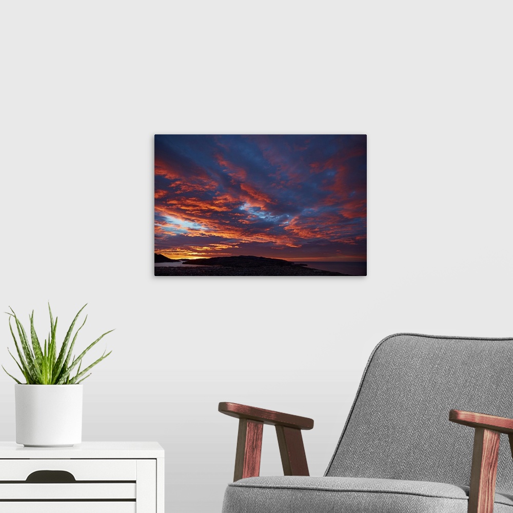 A modern room featuring Sunrise over Otago harbor and Pacific Ocean, Dunedin, South Island, New Zealand.