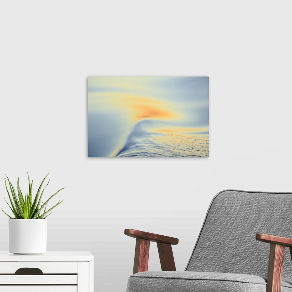 A modern room featuring Sunset colors and patterns on small waves in water.