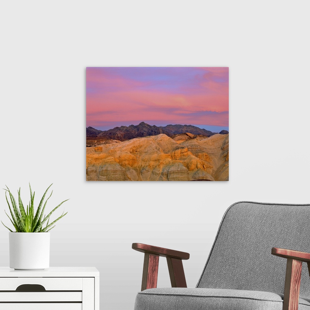 A modern room featuring California, Death Valley National Park. Sunset colors the sky with vibrant pink and purple in Dea...