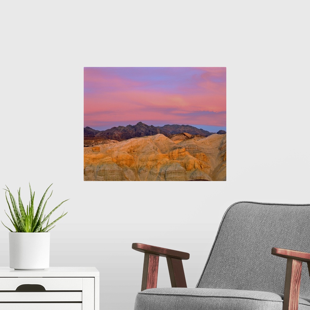 A modern room featuring California, Death Valley National Park. Sunset colors the sky with vibrant pink and purple in Dea...
