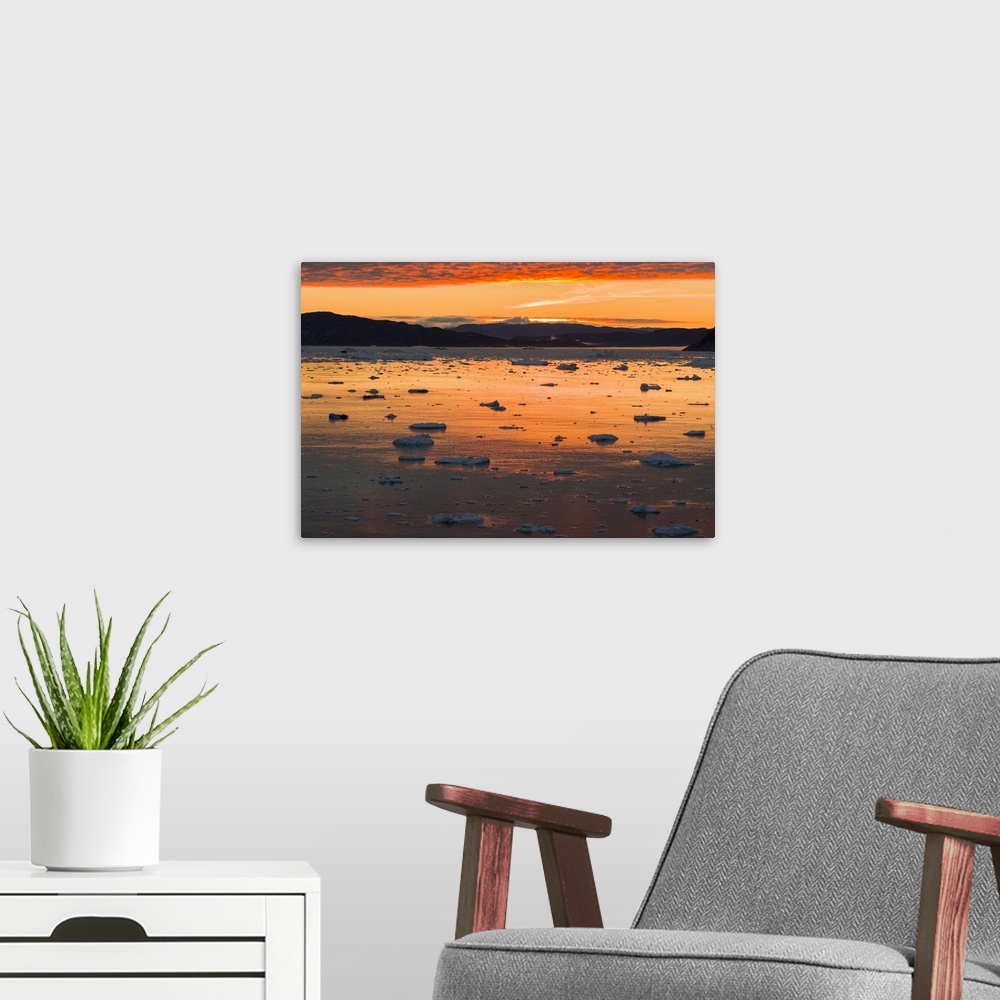 A modern room featuring Sunset over fjord with icebergs close to Eqip Sermia glacier in Denmark's overseas territory, Gre...