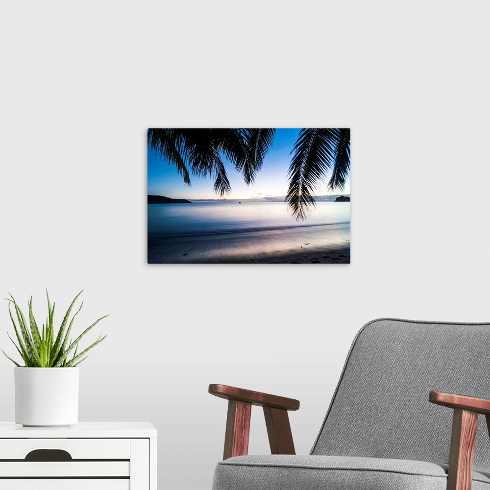 A modern room featuring Sunset over the beach, Naviti, Yasawa, Fiji, South Pacific.