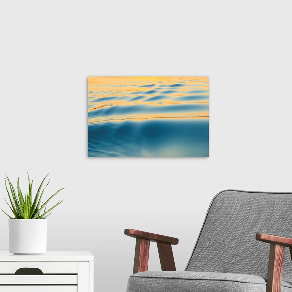 A modern room featuring Sunset refecting on smooth surface, and small ripples, Moses Lake, WA, USA