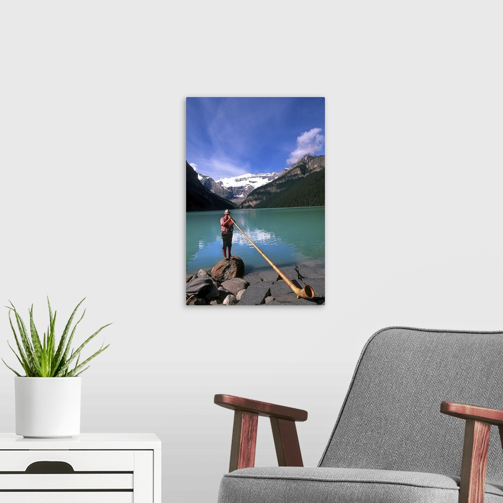 A modern room featuring Swiss Alphorn player at Lake Louise in Banff Canada.