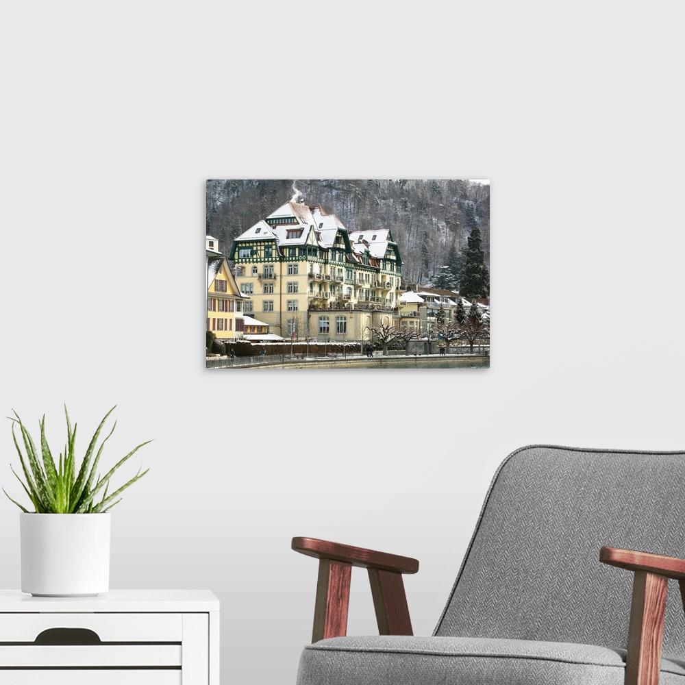 A modern room featuring SWITZERLAND-Bern-THUN:Town Buildings along Aare River / Winter