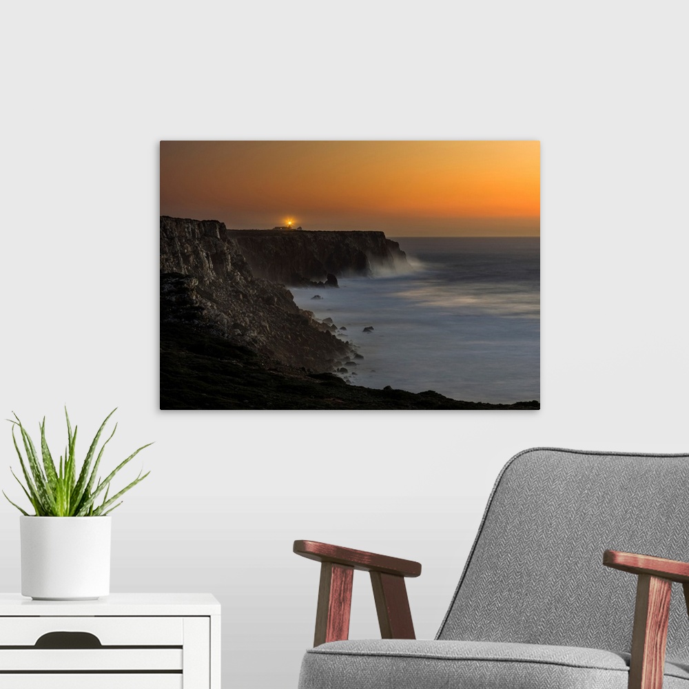 A modern room featuring Cabo de Sao Vincente (Cape St. Vincent) with its lighthouse at the rocky coast of the Algarve in ...