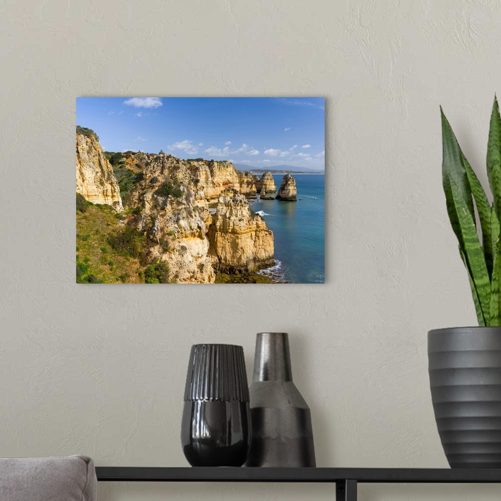 A modern room featuring The cliffs and sea stacks of Ponta da Piedade at the rocky coast of the Algarve in Portugal. Euro...
