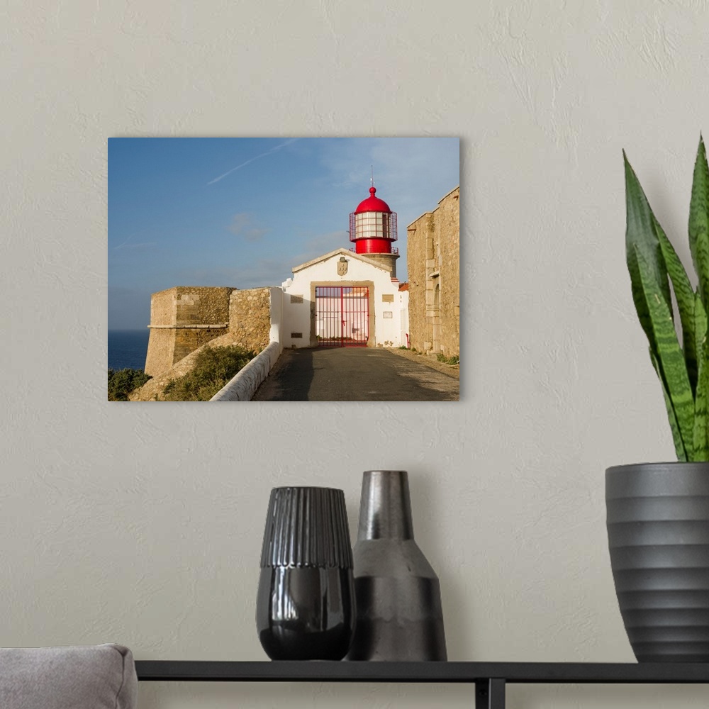 A modern room featuring Cabo de Sao Vincente (Cape St. Vincent) with its lighthouse at the rocky coast of the Algarve in ...