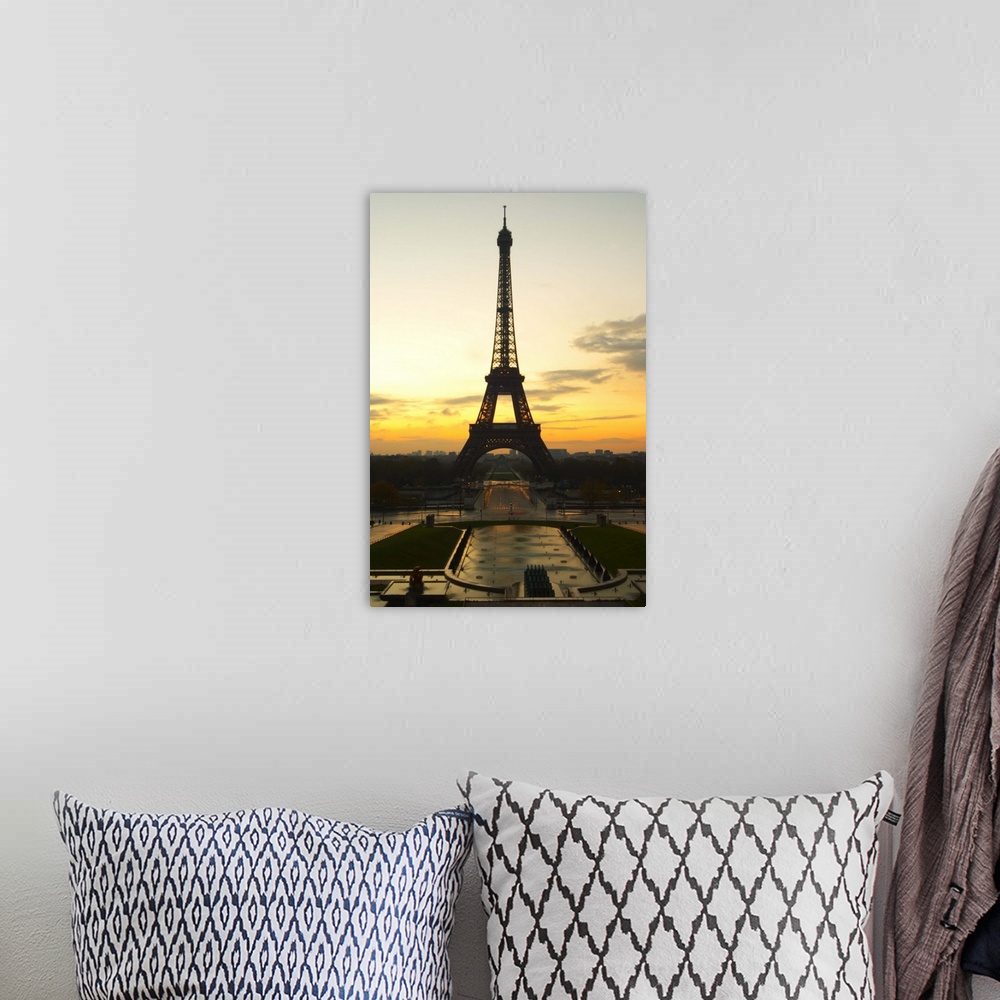 A bohemian room featuring The Eiffel Twoer in Paris in early morning dawn with the sun rising on the horizon, pale blue sky...