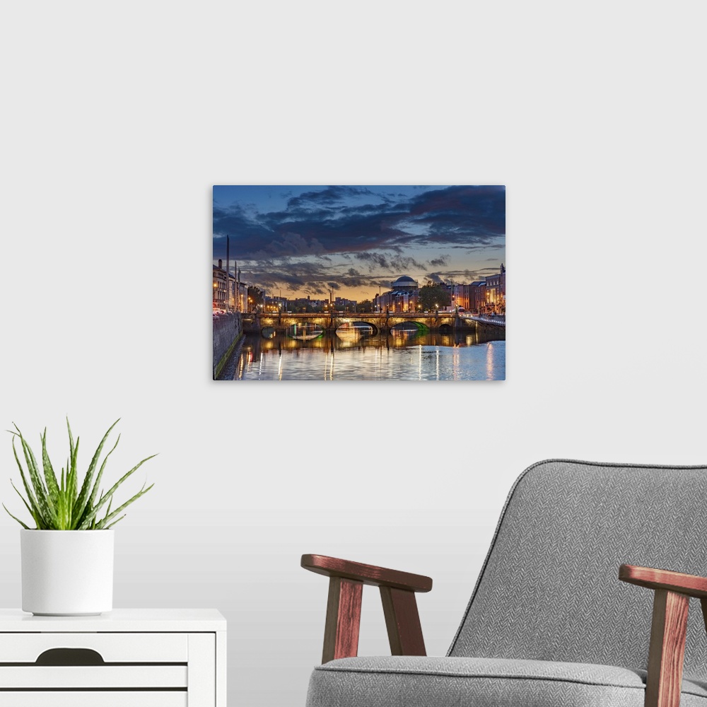 A modern room featuring The Grattan bridge over the river Liffey at dusk in downtown Dublin, Ireland.