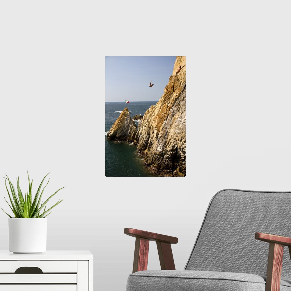 A modern room featuring The La Quebrada Cliff Divers perform for the public from the cliffs of La Quebrada in Acapulco, G...