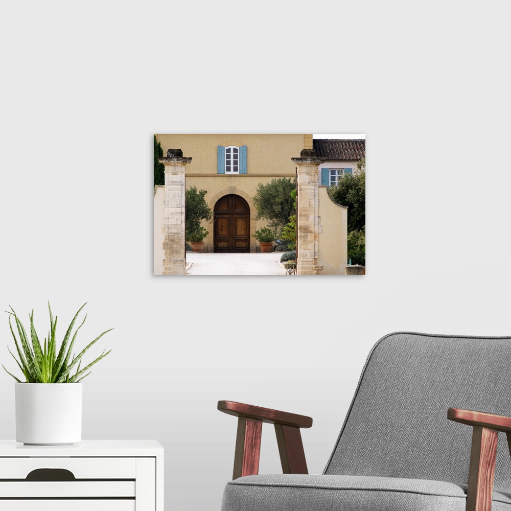 A modern room featuring The main entrance and building with stone portico.  Chateau de Beaucastel, Domaines Perrin, Court...