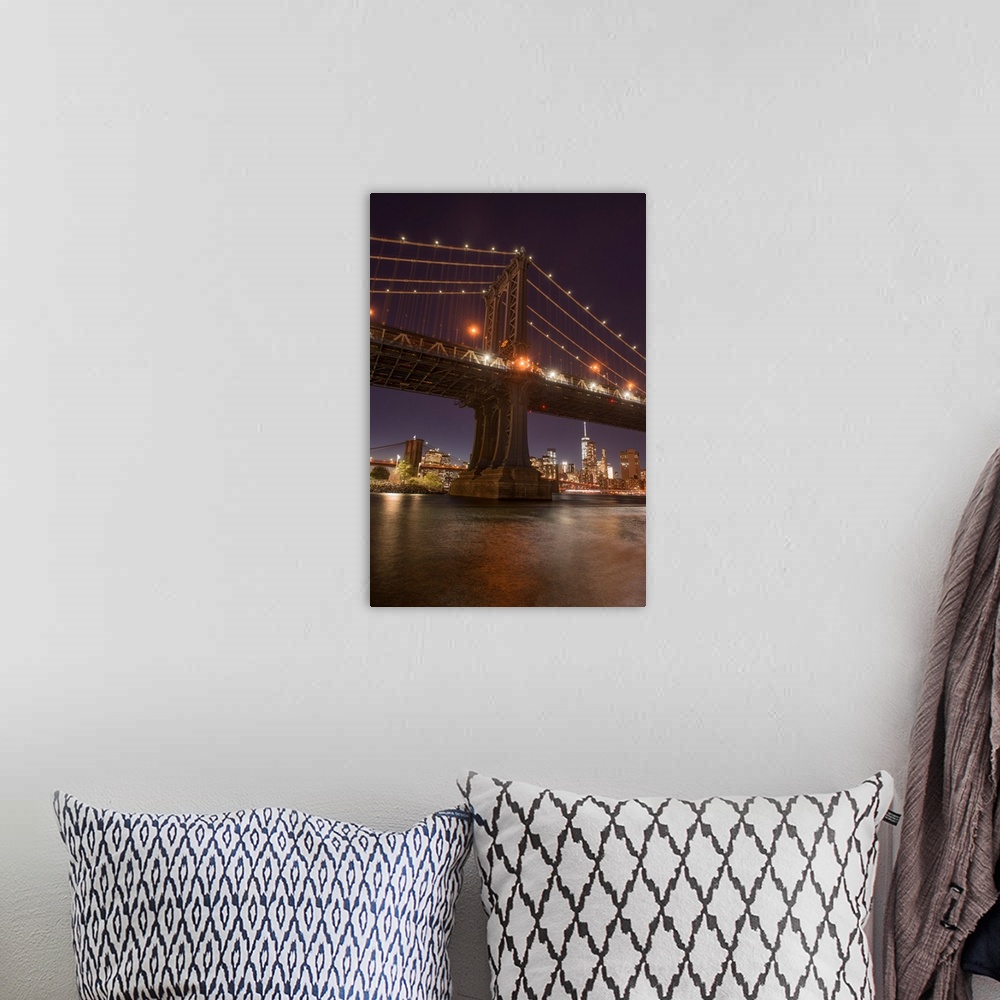 A bohemian room featuring The Manhattan Bridge and Manhattan skyline in the evening light from Brooklyn Bridge Park, New Yo...