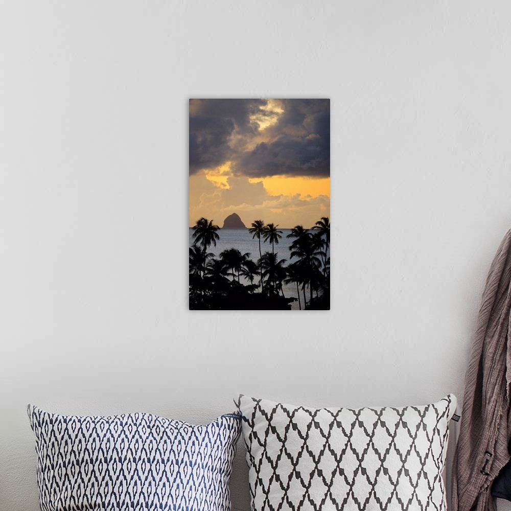 A bohemian room featuring The sun sets behind Diamond Rock viewed from the island of Martinique in the Caribbean Sea.