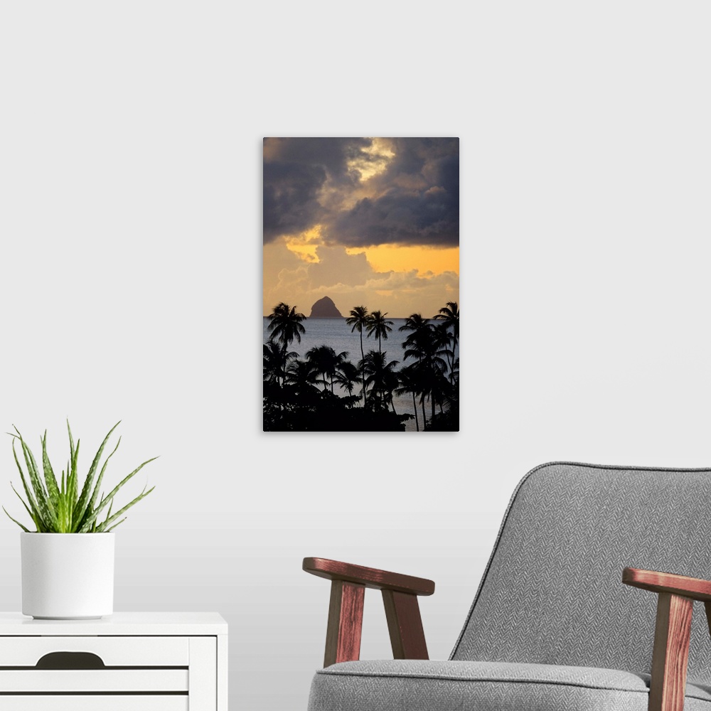 A modern room featuring The sun sets behind Diamond Rock viewed from the island of Martinique in the Caribbean Sea.