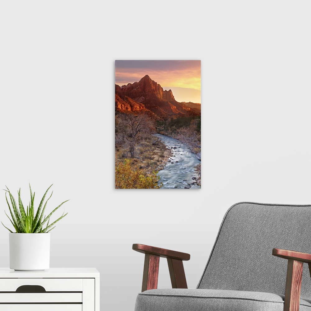 A modern room featuring The Watchman, one of the most prominent mountain formations in Zion National Park, lights up at s...