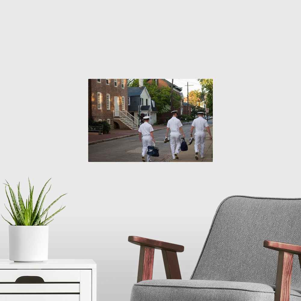 A modern room featuring Three male U.S. Navy cadets walk down street with historic homes (viewed from behind), Annapolis,...