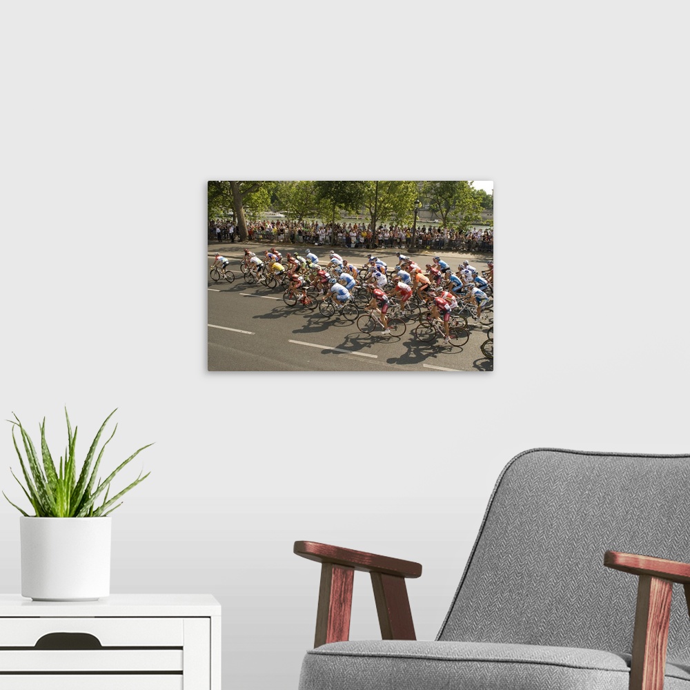 A modern room featuring Thousands line the Quai des Tuileries to welcome the peloton in the Tour de France at the finish ...
