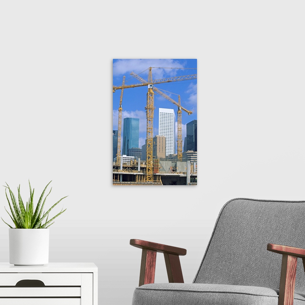A modern room featuring Tower cranes, commercial construction site