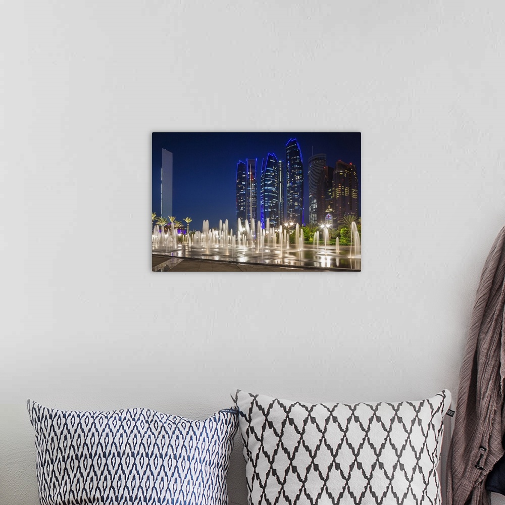 A bohemian room featuring UAE, Abu Dhabi, Emirates Palace Hotel fountains and Etihad Towers, dusk