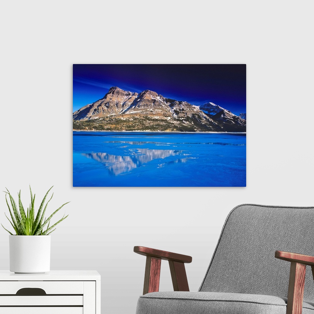 A modern room featuring Upper Waterton Lake in winter in Waterton lakes National Park in Alberta Canada