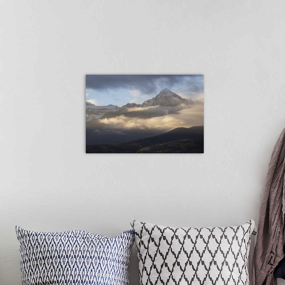 A bohemian room featuring USA, Colorado, Uncompahgre National Forest. Sunrise on clouds below Mount Sneffels. United States...