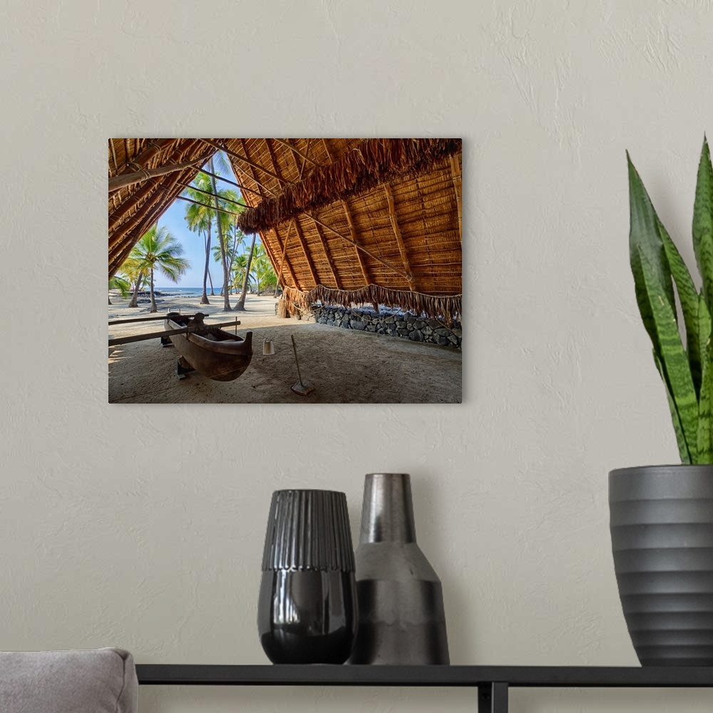 A modern room featuring USA, Hawaii, Big Island. Canoe on display inside the Halau thatched A-frame structure at the Nati...