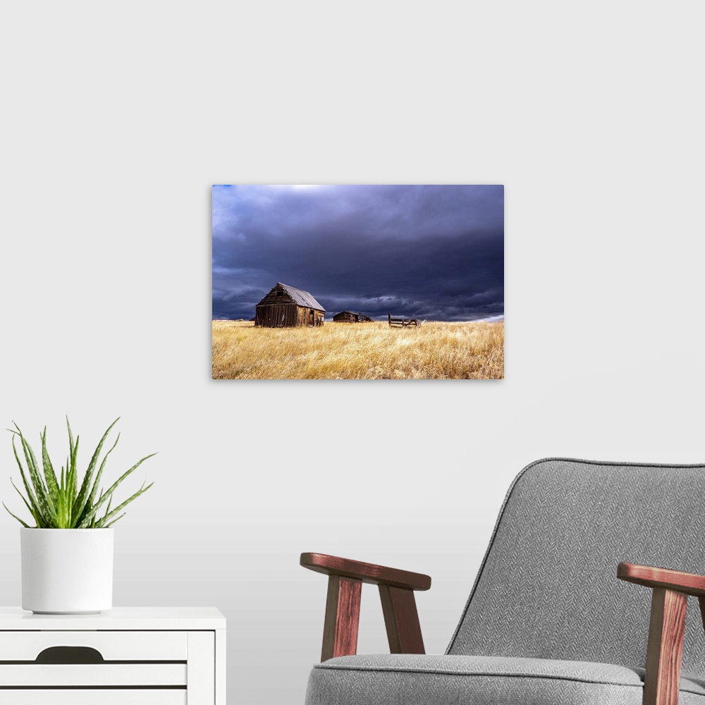 A modern room featuring USA, Idaho, Highway 36, Liberty storm passing over old wooden barn. United States, Idaho.