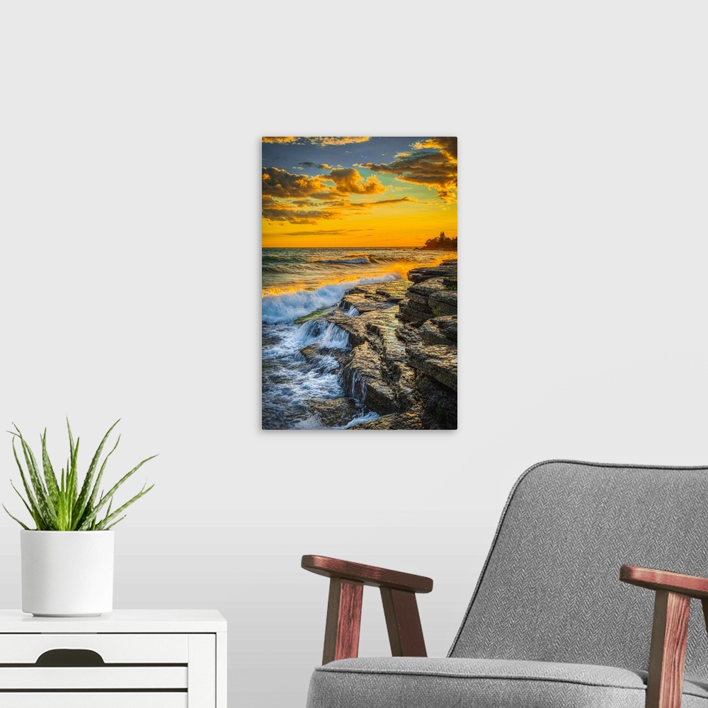 A modern room featuring USA, New York, Lake Ontario. Sunset waves on rocky shoreline. United States, New York.