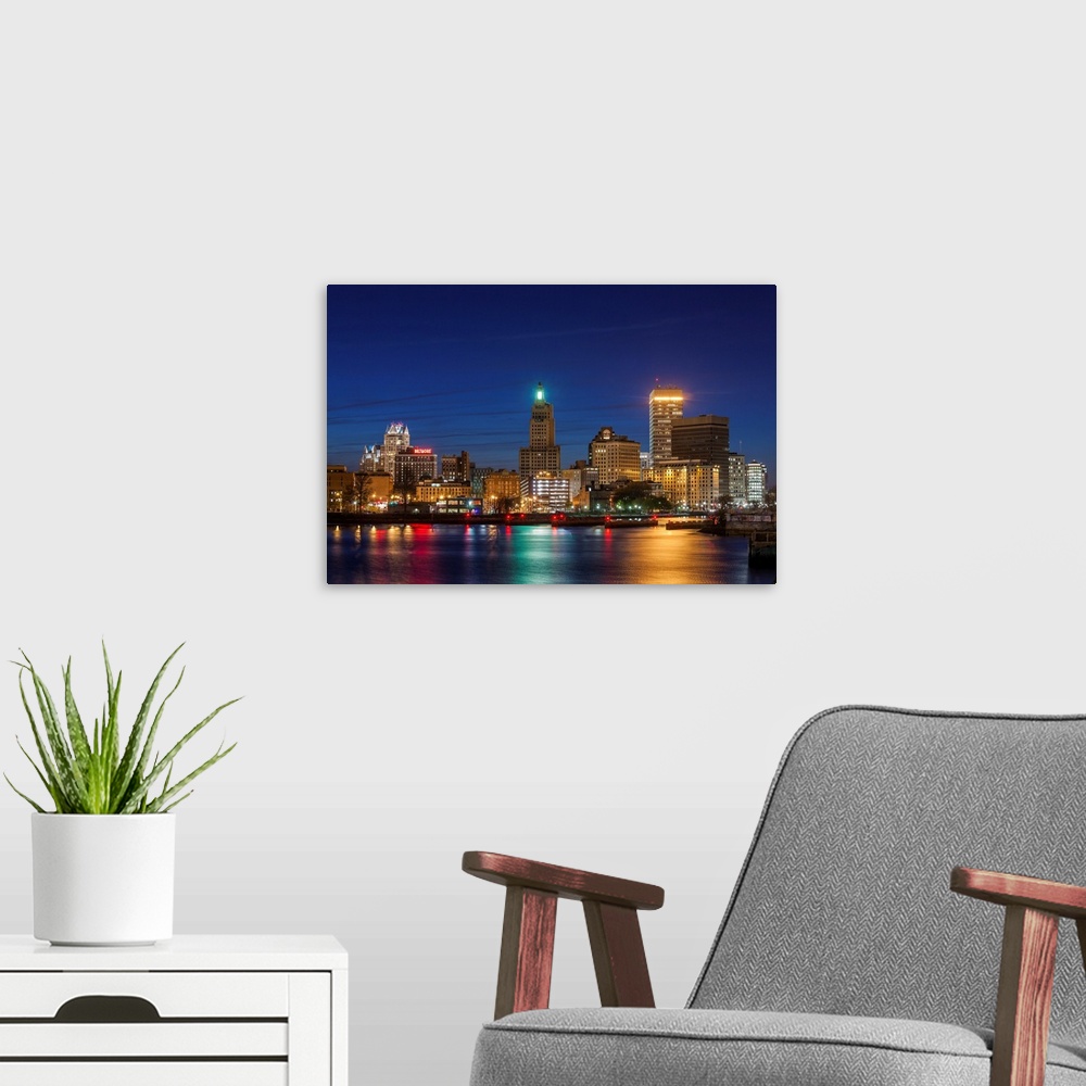 A modern room featuring USA, Rhode Island, Providence, city skyline from the Providence River at dusk