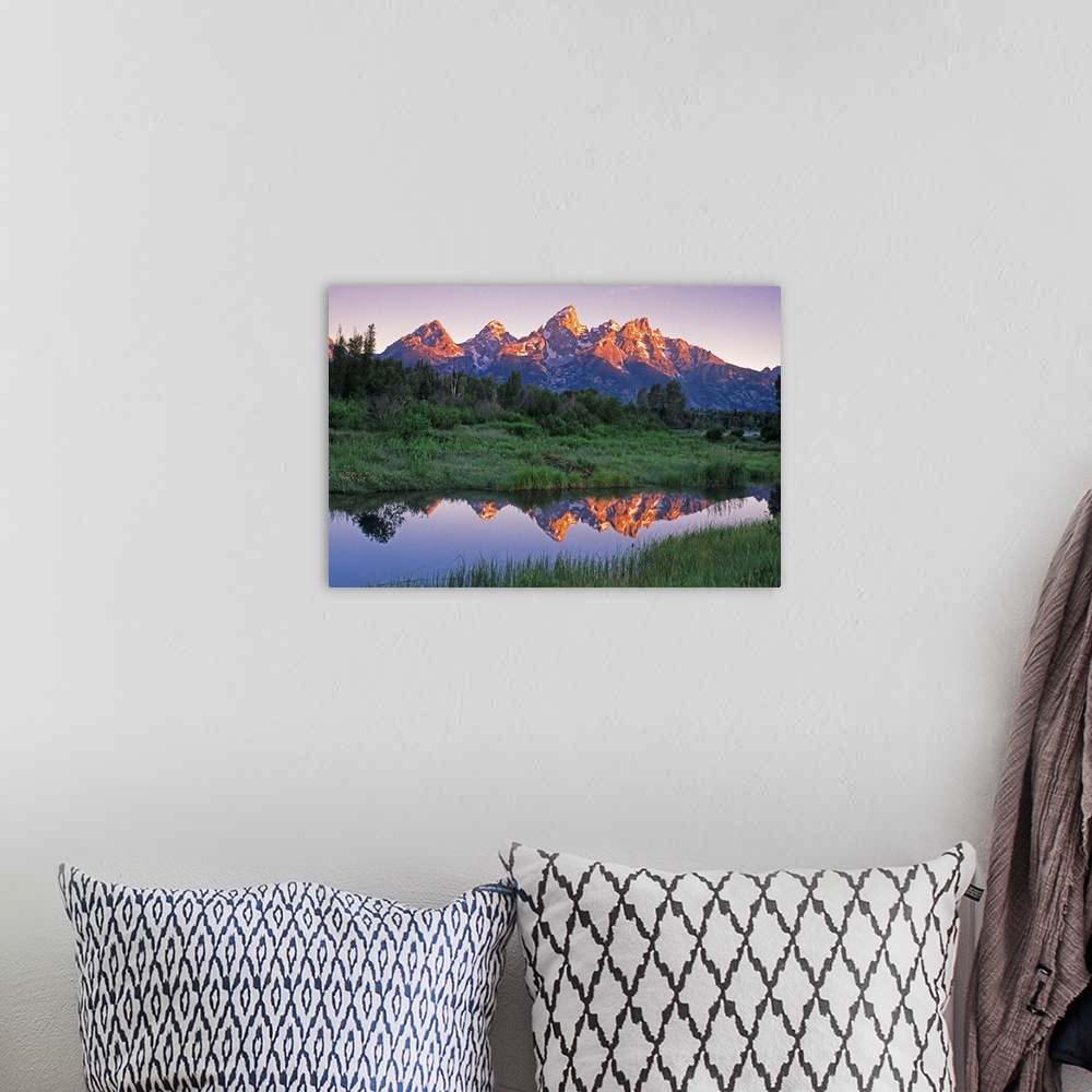 A bohemian room featuring USA, Wyoming, Grand Teton National Park. Mountains reflect in beaver pond at sunrise.
