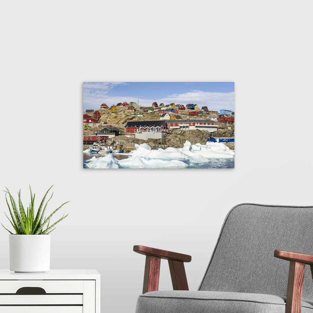 A modern room featuring Uummannaq harbor and town, northwest of Greenland, located on an island in the Uummannaq Fjord Sy...