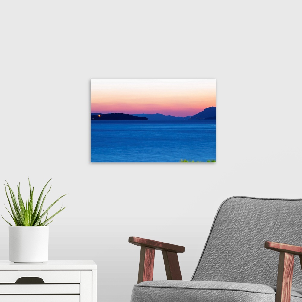 A modern room featuring Sunset over the sea. View over the islands Daksa and others. House lights. Dark blue sea. Uvala S...
