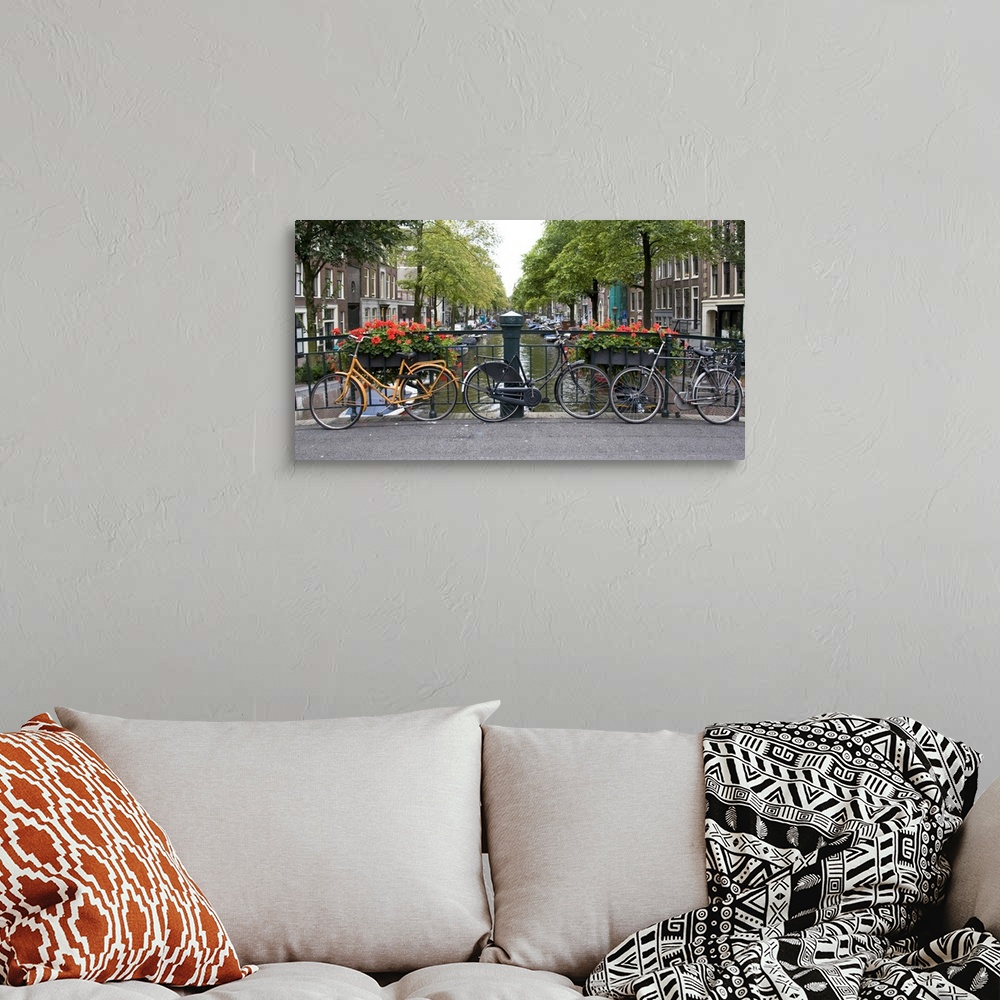 A bohemian room featuring View from a bridge over a canal in Amsterdam with colorful bikes and red flowers