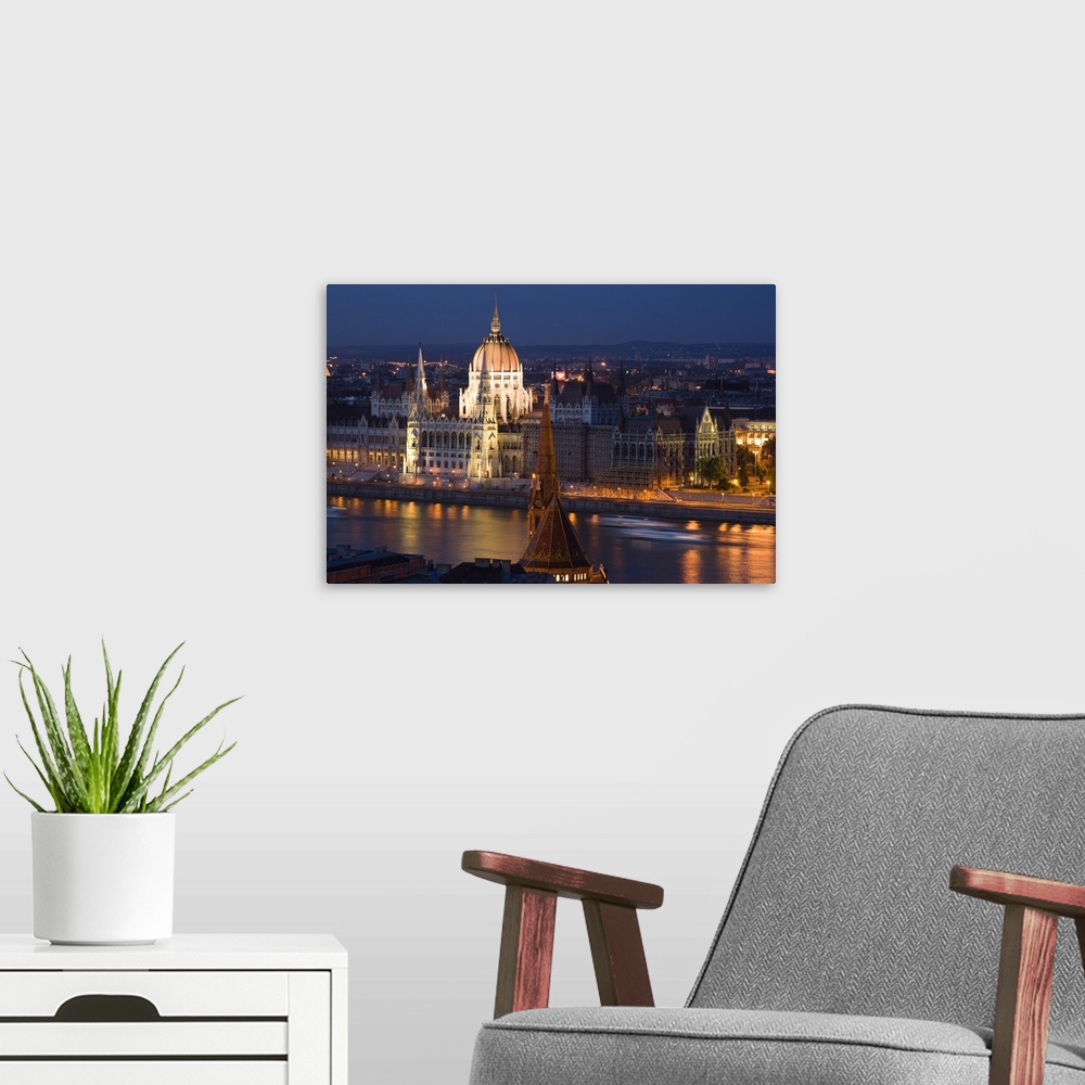 A modern room featuring View of Parliament Buildings along Danube River at dusk, Budapest, Capital of Hungary, Europe