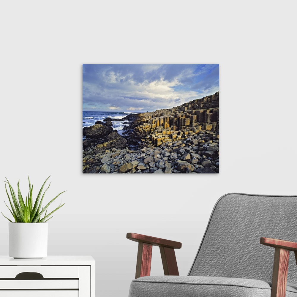 A modern room featuring Northern Ireland, County Antrim, Giant's Causeway. Visitors comb the basalt blocks at the Giant's...
