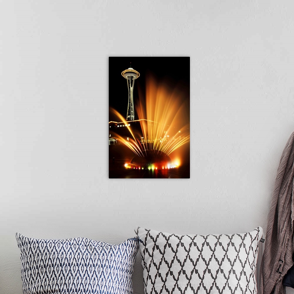 A bohemian room featuring USA, Washington State, Seattle, Space Needle tower with fountain in foreground at night.