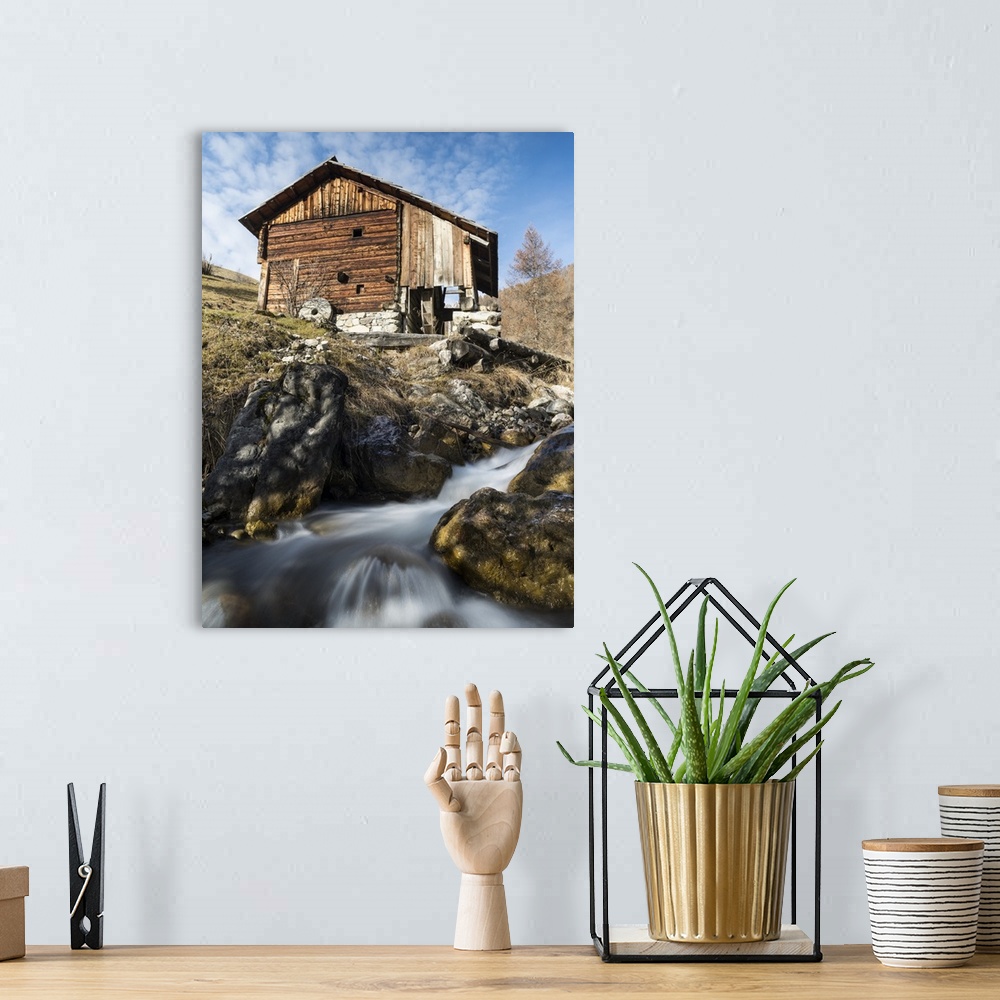 A bohemian room featuring Water mills of the viles of Mischi und Seres, village of Campill. Central South Tyrol, Italy.