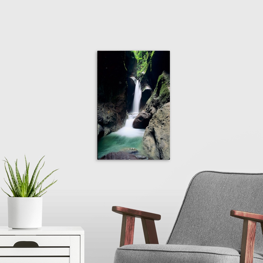 A modern room featuring A waterfall plunges through the Gorges de la Falais on the Island of Martinique in the Caribbean ...