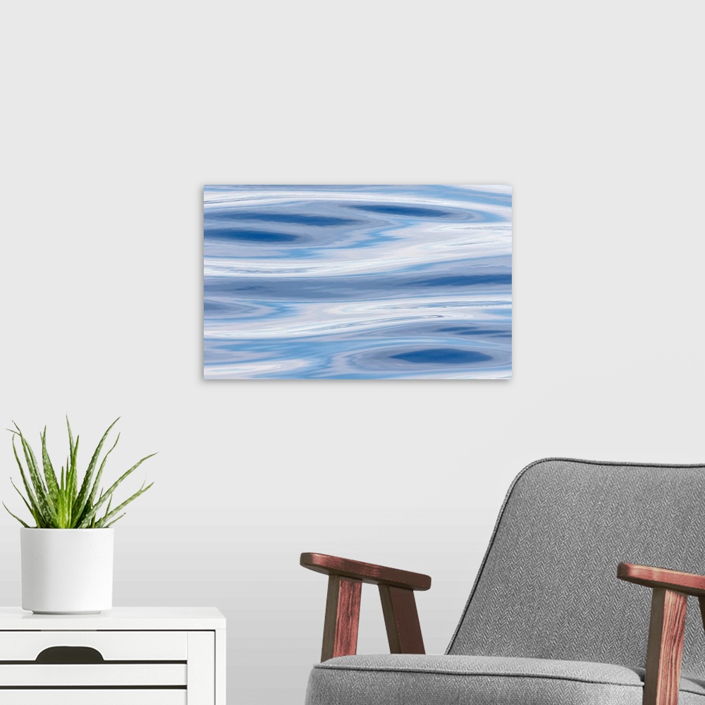 A modern room featuring Waves reflecting sky in blue, grey and silver. Atlantic ocean near the coast of southern greenlan...