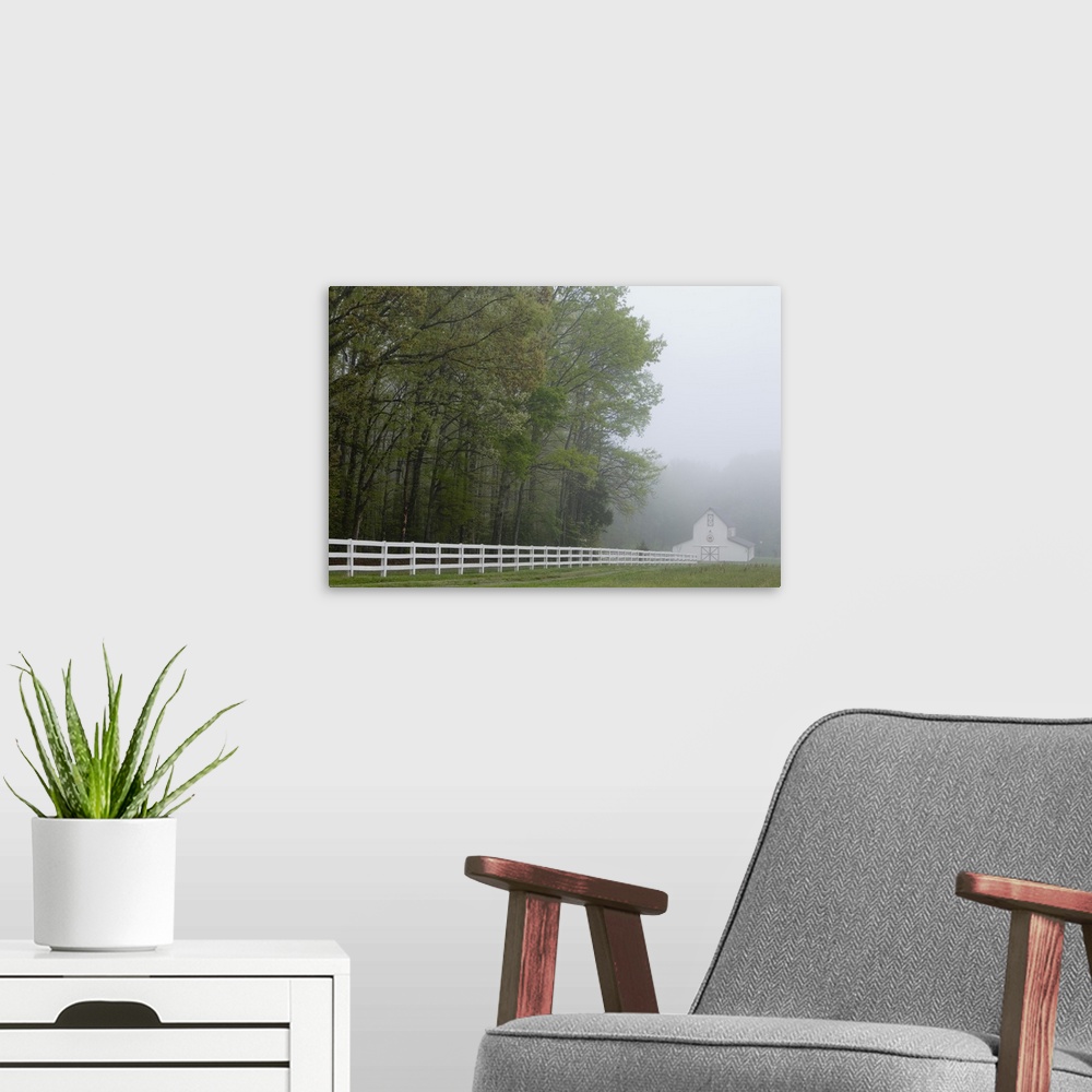 A modern room featuring White farmhouse and fence in mist, Powhatan, Virginia, United States.